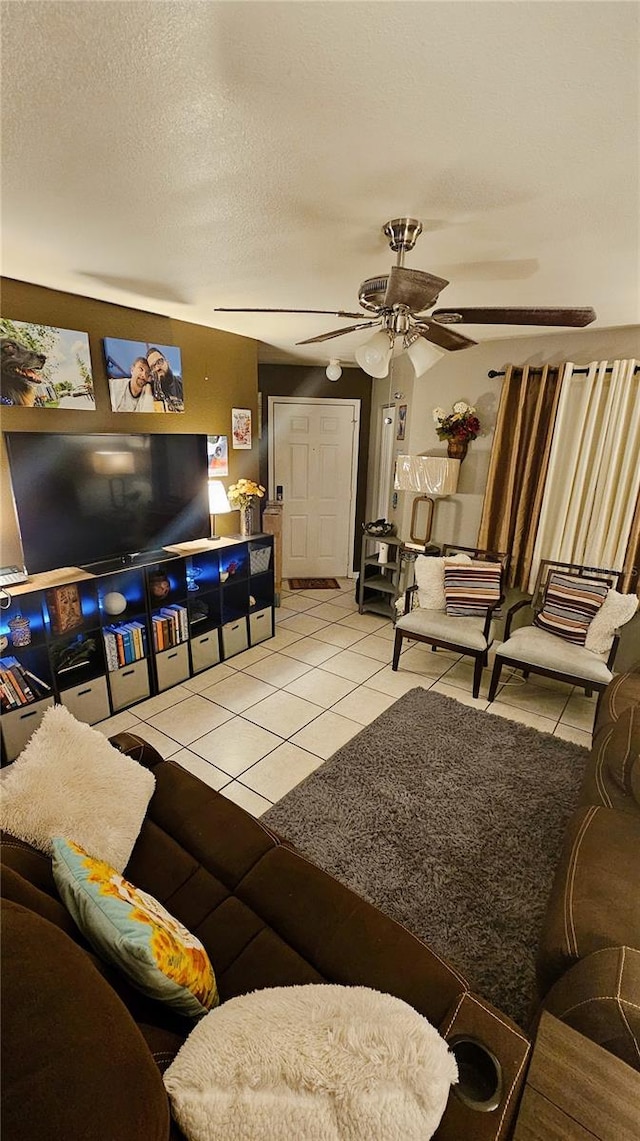 tiled living room with ceiling fan and a textured ceiling