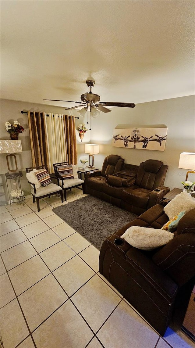 living room featuring ceiling fan and light tile patterned floors