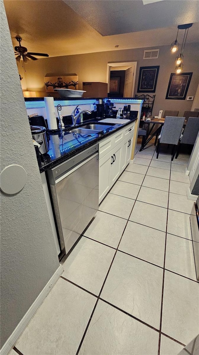 kitchen featuring sink, stainless steel dishwasher, ceiling fan, light tile patterned floors, and white cabinetry