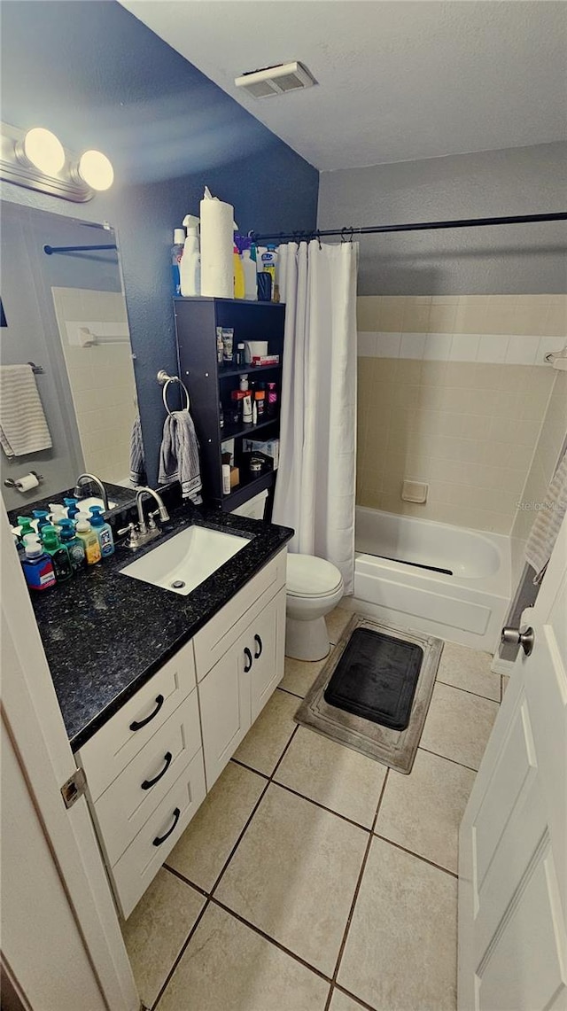 full bathroom featuring tile patterned floors, vanity, shower / bath combo, and toilet