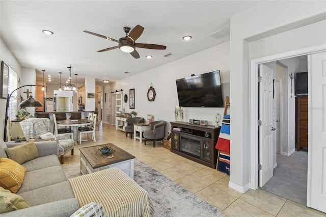 living room with ceiling fan and light tile patterned flooring