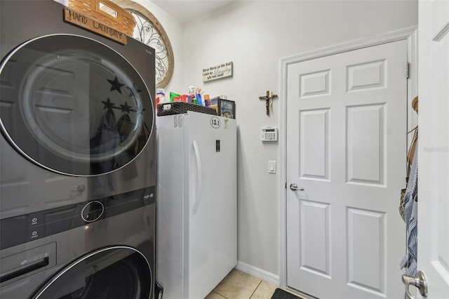 laundry room with stacked washer / dryer and light tile patterned flooring