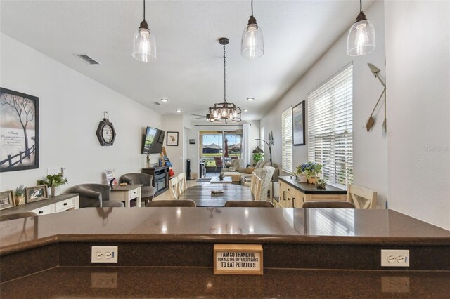 kitchen featuring decorative light fixtures, a notable chandelier, and plenty of natural light