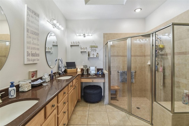 bathroom with an enclosed shower, vanity, and tile patterned flooring