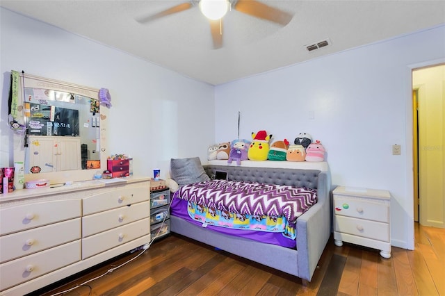 bedroom with ceiling fan and dark hardwood / wood-style flooring