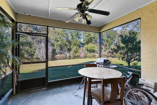 sunroom with ceiling fan and a healthy amount of sunlight