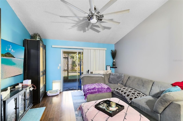 living room featuring a textured ceiling, ceiling fan, vaulted ceiling, and dark hardwood / wood-style flooring