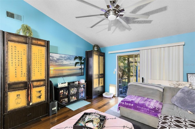 bedroom with vaulted ceiling, ceiling fan, dark hardwood / wood-style floors, a textured ceiling, and access to outside