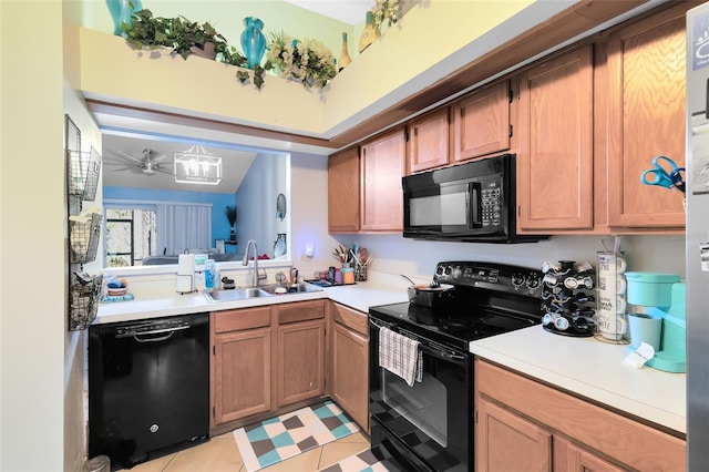 kitchen featuring sink, light tile patterned floors, and black appliances