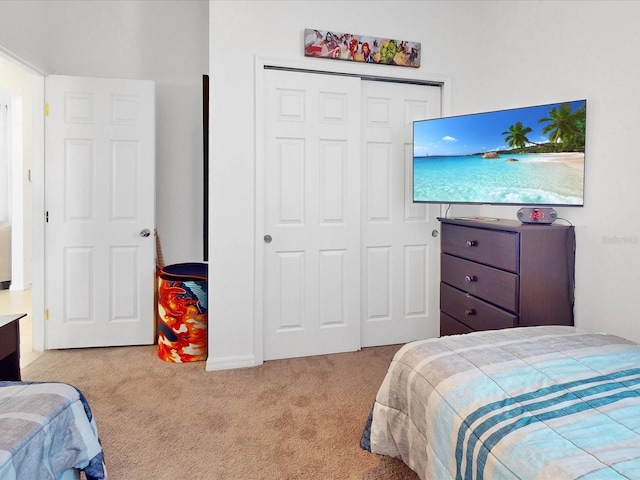 carpeted bedroom with a closet