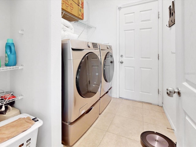 laundry room featuring washing machine and dryer and light tile patterned floors