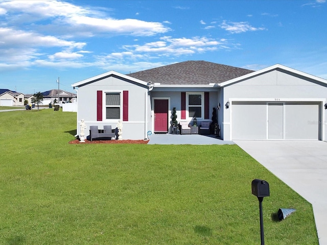 view of front facade featuring a garage and a front lawn