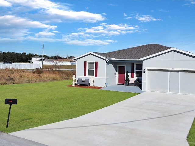 view of front of home featuring a garage and a front lawn