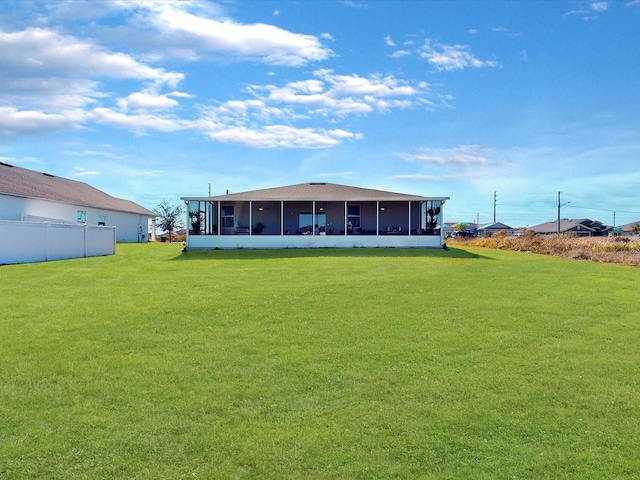 rear view of property with a lawn