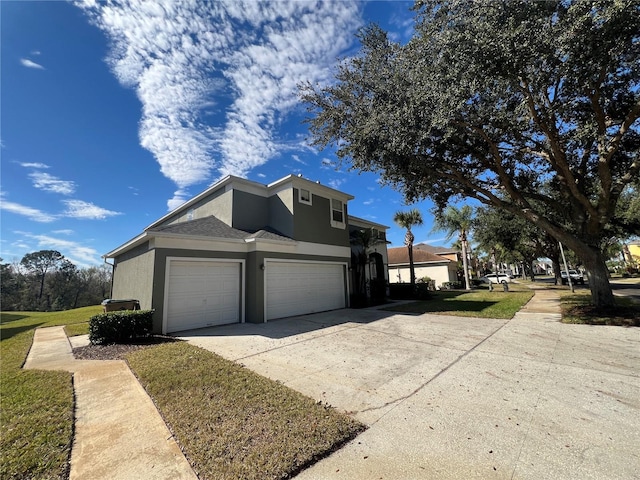 view of home's exterior with a yard and a garage