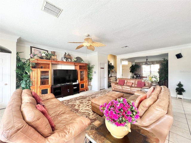 living room with ornamental molding, visible vents, a textured ceiling, and light tile patterned floors