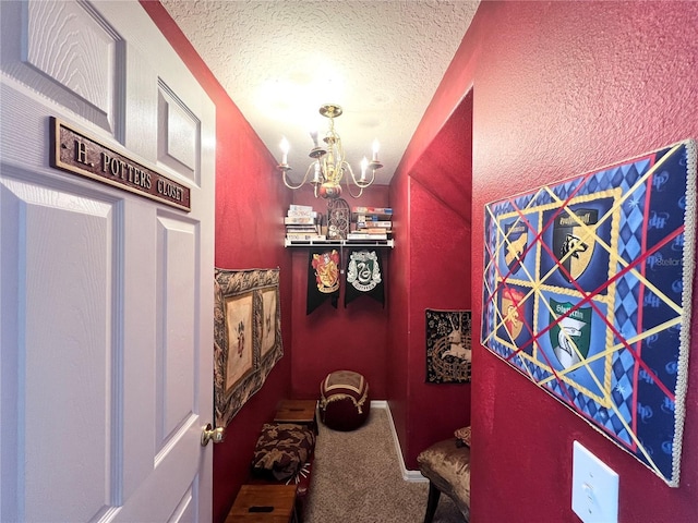 interior space with an inviting chandelier, carpet floors, and a textured ceiling