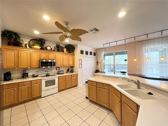 kitchen featuring visible vents, white range with electric cooktop, stainless steel microwave, light countertops, and a sink