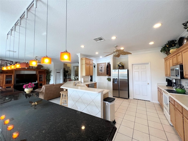 kitchen featuring light tile patterned floors, a breakfast bar, hanging light fixtures, stainless steel appliances, and ornamental molding