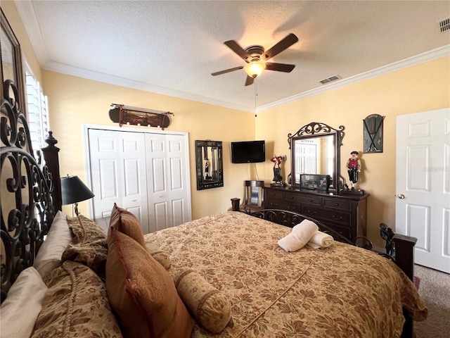 carpeted bedroom with ornamental molding, visible vents, ceiling fan, and a textured ceiling