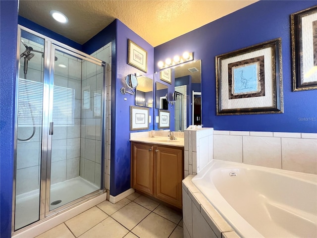 bathroom featuring tile patterned flooring, vanity, shower with separate bathtub, and a textured ceiling