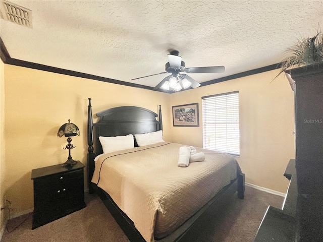 bedroom with a textured ceiling, dark colored carpet, ceiling fan, and visible vents