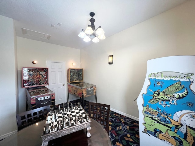 recreation room featuring visible vents, a notable chandelier, and baseboards