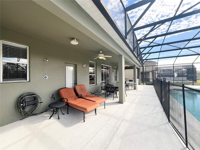 view of patio featuring a lanai and ceiling fan