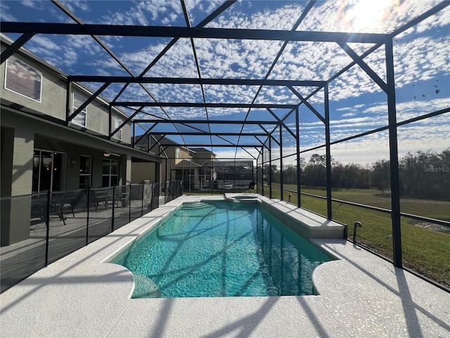 view of pool featuring a yard, a lanai, a patio area, and a pool with connected hot tub