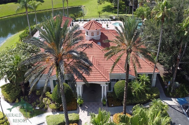 exterior space with a tiled roof and a water view