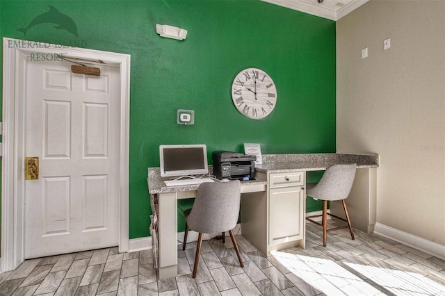 office area featuring wood tiled floor, ornamental molding, and baseboards