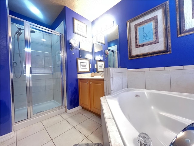 full bathroom featuring a garden tub, a stall shower, vanity, a textured ceiling, and tile patterned flooring