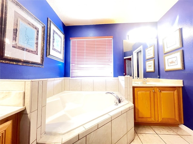 bathroom with a bath, vanity, and tile patterned floors