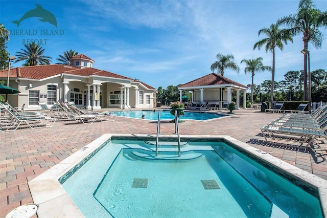 pool with a patio area and a gazebo