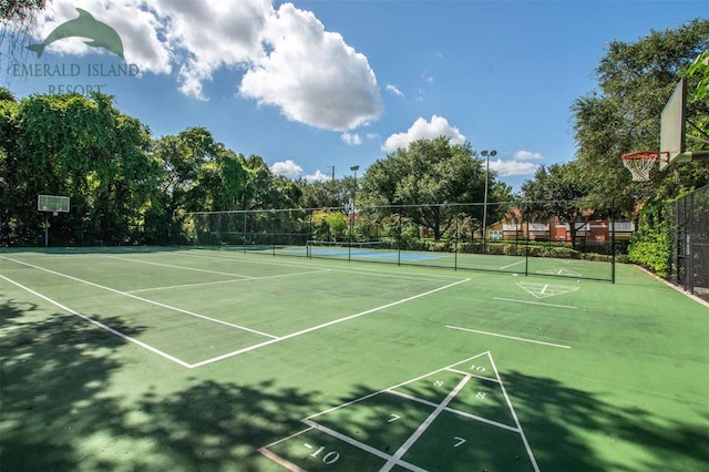 view of tennis court with fence