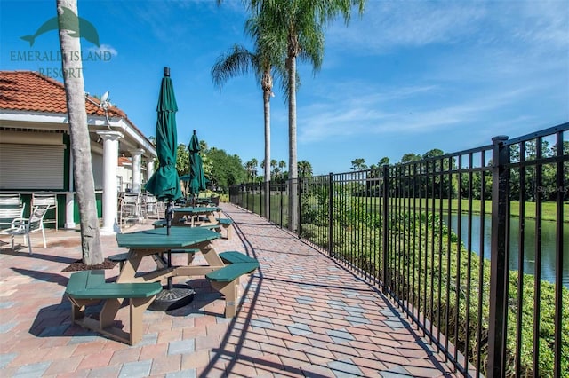 view of community with fence and a patio