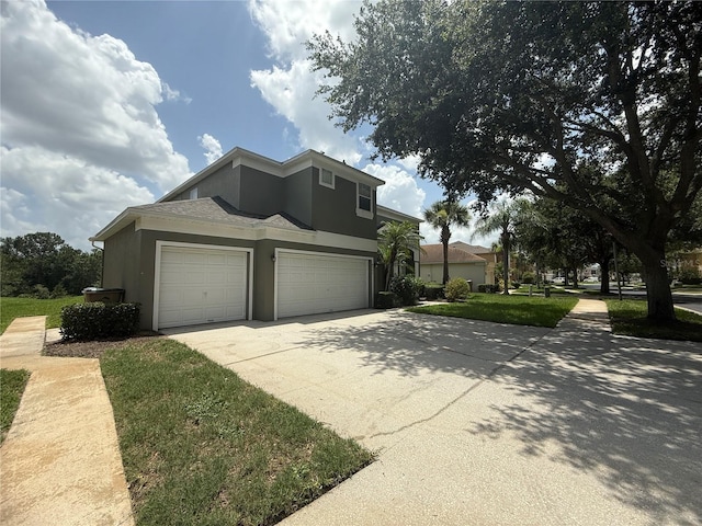 8557 La Isla Dr, Kissimmee, FL 34747 - view of front of property featuring stucco siding, driveway, and a garage