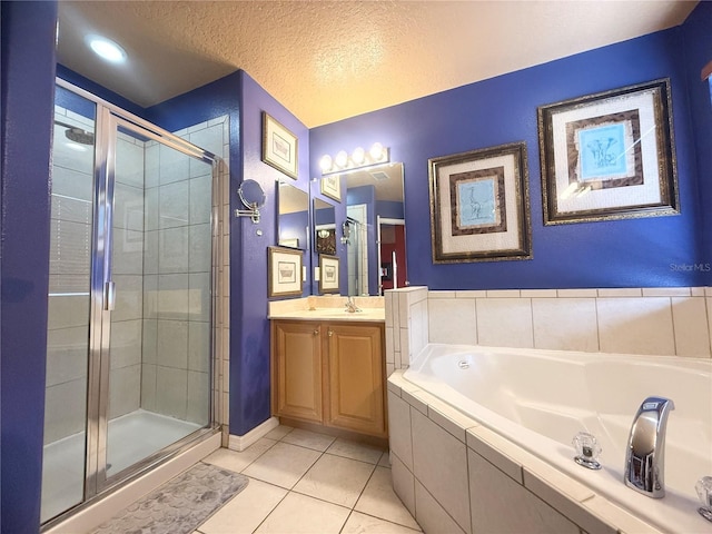 8557 La Isla Dr, Kissimmee, FL 34747 - bathroom featuring tile patterned flooring, a shower stall, a garden tub, vanity, and a textured ceiling