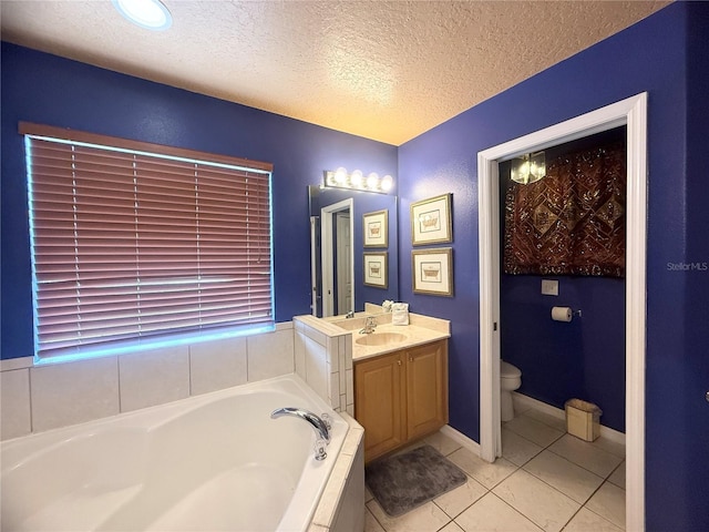 8557 La Isla Dr, Kissimmee, FL 34747 - bathroom featuring a garden tub, vanity, a textured ceiling, toilet, and tile patterned flooring