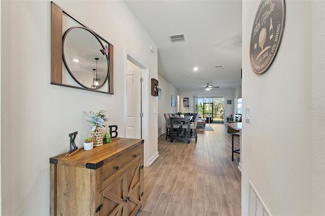 hall with light hardwood / wood-style flooring