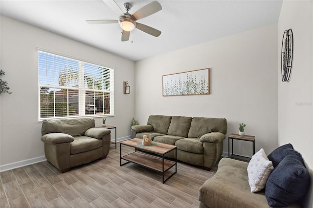 living room featuring ceiling fan and light wood-type flooring