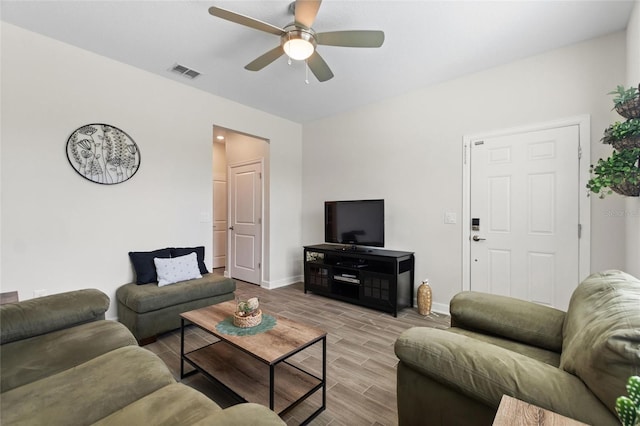 living room with ceiling fan and light wood-type flooring