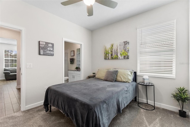 carpeted bedroom featuring ceiling fan and connected bathroom