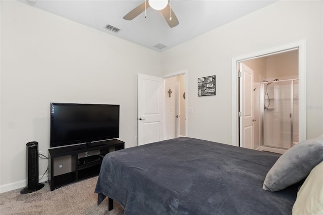 carpeted bedroom featuring ceiling fan and ensuite bath