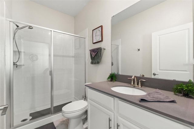 bathroom featuring toilet, vanity, and walk in shower