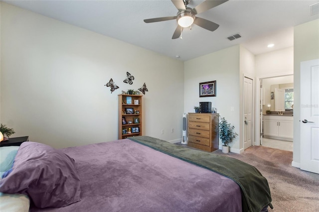 carpeted bedroom featuring ceiling fan and ensuite bathroom