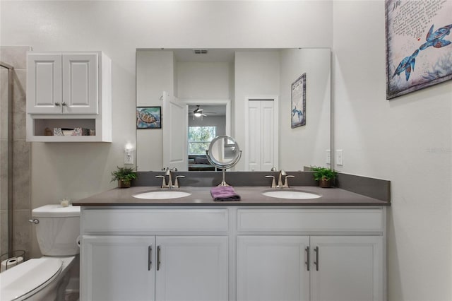 bathroom with ceiling fan, toilet, and vanity