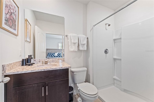 bathroom with vanity, toilet, and walk in shower