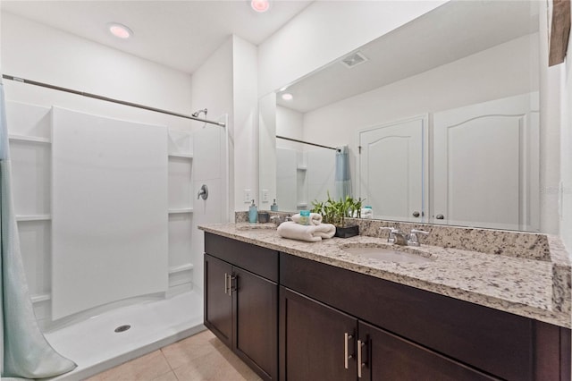 bathroom with walk in shower, tile patterned floors, and vanity