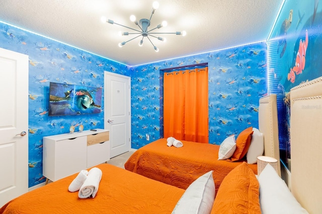 bedroom featuring a textured ceiling and a notable chandelier